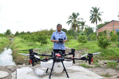 Nguyễn Văn Hường, 64, operates his XAG P150 agricultural drone to efficiently protect his orchard in Vietnam. (PRNewsfoto/XAG)