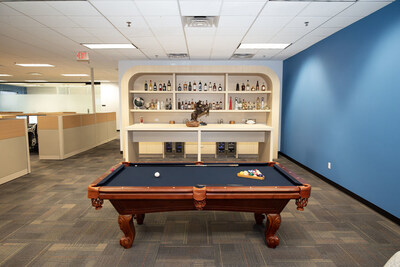 The living room with custom bar and pool table.
