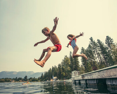 Children jumping into lake