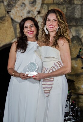 Katherine Duran and Sofía Perazzo accepting The Community Impact Award from The Law Firm Network