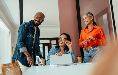A man and two women working together in an office setting.