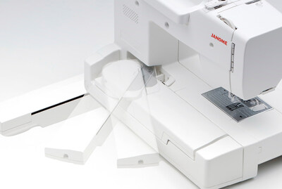 The embroidery arm sliding in and out on a Janome Memory Craft 1000.