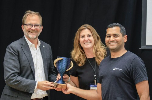 Matt Petersen, LACI President and CEO, and Adrienne Lindgren, LACI Senior Vice President of Unlocking Innovation, present LA Resilient Rebuilding Cup trophy to Vikas Enti, co-founder and CEO of Reframe Systems