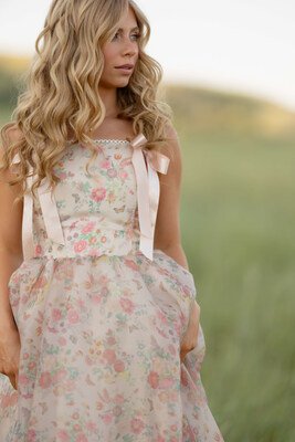 Jessa Kinderknecht in the Francesca Dress — soft blush organza, silky bow straps, and delicate florals made for daydreams, twirls, and timeless beauty.