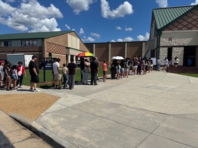 Attendees start to line up ahead of the event beginning.