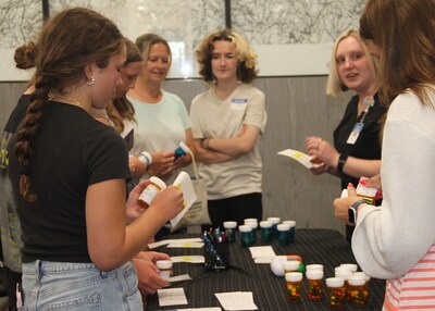 Event attendees learning how to properly label medications at Tareen Dermatology's Careers in Medicine.