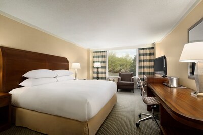 A spacious king guest room at DoubleTree by Hilton Stamford, offering comfort and functionality with thoughtful amenities and natural light.