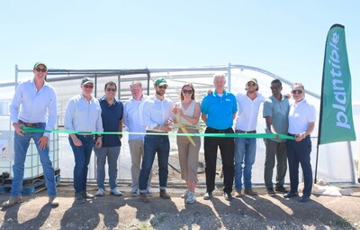 Plantible ribbon cutting in front of its newly constructed greenhouse, celebrating the opening of the company's first commercial facility.