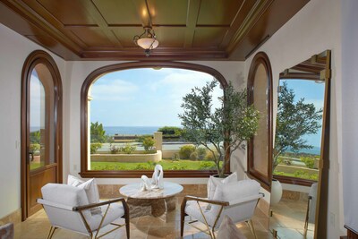 Intricate ceilings with a view through arches windows at 3300 Ocean Blvd.
