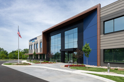 The main entrance of Heaven Hill Brands' new 815 Building features a striking blue accent wall with floor-to-ceiling glass and copper-toned framing, demonstrating ARCO's adaptation of tilt-wall construction for commercial office aesthetics.