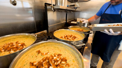 A community partner in the San Francisco area adds donated Chick-fil-A protein to a filling for chicken pot pie.