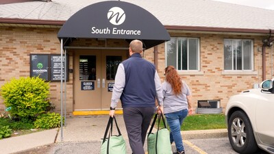 A community partner brings donations inside an organization to be repurposed and served to those in need.