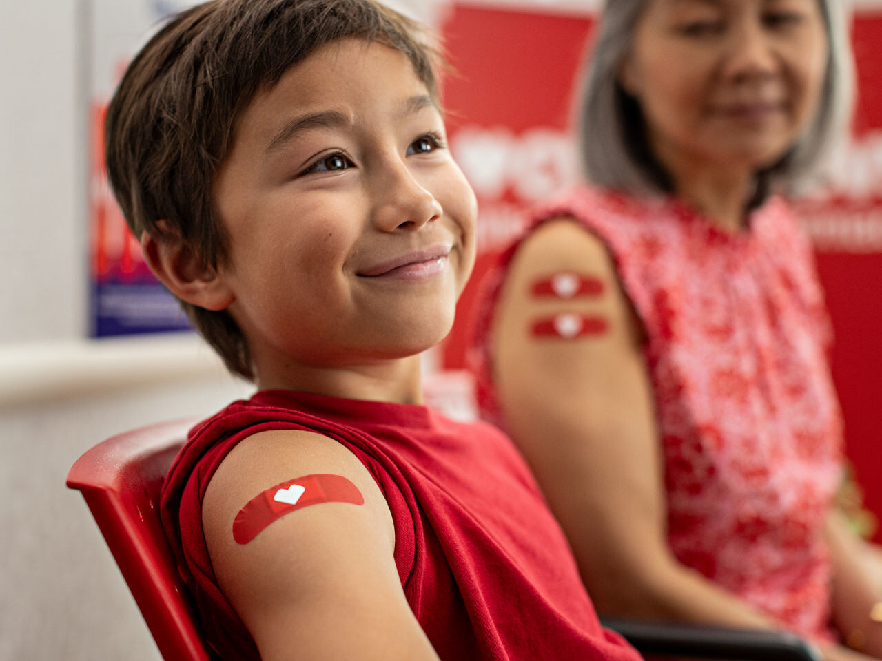 Flu vaccinations available at CVS Pharmacy. (Photo of boy and woman post vaccination.)