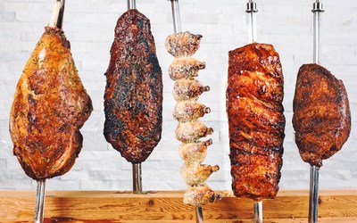 At Texas de Brazil we cook all of our meats the authentic Brazilian gaucho way, over an open flame using natural wood charcoal, to give our meats a deeper and more intense flavor with just the right amount of smokiness. (PRNewsfoto/Texas de Brazil)