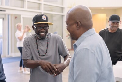 Men's Health Fair attendees share a laugh.