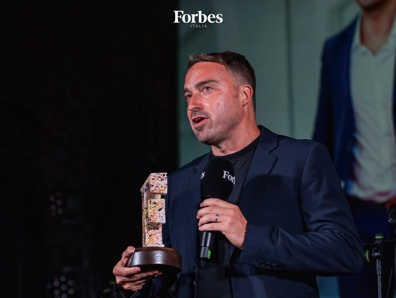 Film producer Nicola Liguori receives the "2025 Unconventional Excellence" award from Forbes during the Venice Film Festival