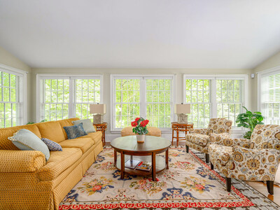 A lovely sunroom on the main living level fills with natural light. It’s an ideal spot for conversation with friends or for curling up with a good book. VirginiaLuxuryAuction.com.