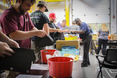 American Crane & Equipment Corporation volunteers packing essential school supplies for local students