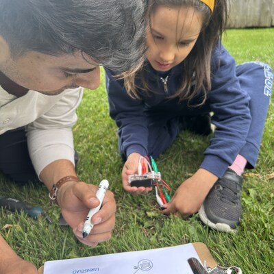 Hands-on learning in action: a student tests soil moisture with FarmBeat micro:bits to select the perfect site for a pumpkin patch. (CNW Group/Pickering College)