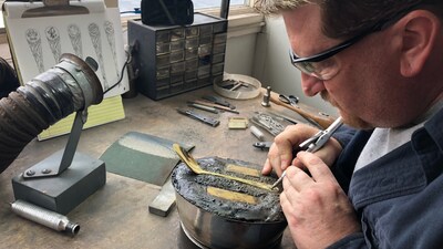 Designer Eric Lawrence hand-tooling a flatware pattern