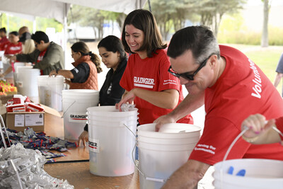 Team members assembling disaster relief buckets