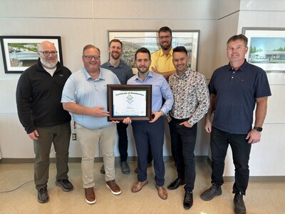 DIPRA Regional Engineer, M.A.Sc, P.Eng, presents a certificate honoring the City of Corner Brook, Newfoundland, Canada, to the Century Club, which pays tribute to the legacy of cast iron drinking water pipes, to Public Works Department staffers, including Erik Neilson, director of Engineering and Public Works (second from left), Keith Costelo, manager public works at City of Corner Brook (right), and Martin Phinney, an engineer with McWane Canada (second from right).