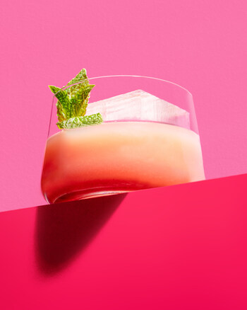 A vibrant cocktail served over crystal-clear ice, garnished with fresh mint; Photo Credit: Ingredient