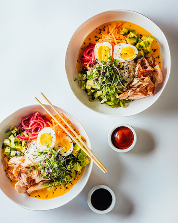 A colorful bowl of fresh veggies, tender salmon, creamy avocado and eggs; Photo Credit: Ingredient