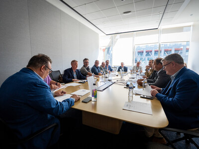 At the head of a long table, Spero Georgedakis, CEO and founder of Good Greek Moving & Storage, leads a discussion with U.S. senators and representatives.