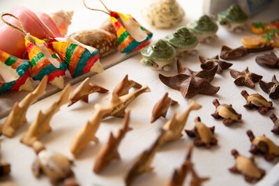 Pictured here, handcrafted wooden keepsakes made by local artisans and commissioned by the Sandals Foundation are used by couples as wedding favors—part of Sandals and Beaches Resorts’ new eco-conscious wedding experiences.