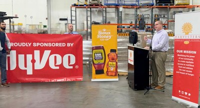 Members of the Sioux Honey Co-op and Hy-Vee grocery stores look on as Stephen Davis, president and CEO of Harvesters Community Food Network, discusses food insecurity in the Kansas City area on Wednesday during an event held to celebrate the largest single donation of honey at the food bank. Sioux Honey and Hy-Vee donated  6,480 bottles of Sue Bee® honey – enough honey to coat the entire football field at Arrowhead Stadium.