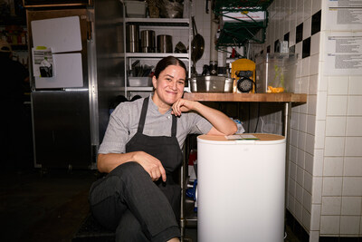 Mary Attea, Executive Chef of Raf’s, with a Mill food recycler in the Raf’s kitchen for Mill's Make Food Not Waste Restaurant Week.