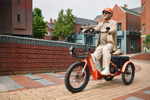 An elderly gentleman is using the new Viribus electric tricycle.