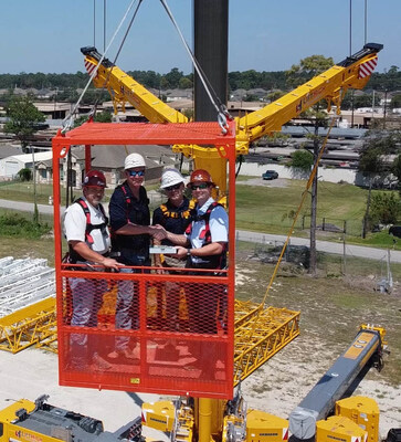 Pictured left to right: Sam Land, LiftHigh Branch Manager; Mike Appling Jr., LiftHigh CEO; Blake Patterson, Cadence Bank Senior Vice President of C&I Houston; and Brad Hopper, LiftHigh CFO. The team seals the partnership with a handshake from a man-basket lifted by LiftHigh’s 400-ton Liebherr LTM 1350-6.1—symbolizing strength, trust, and new heights in collaboration.