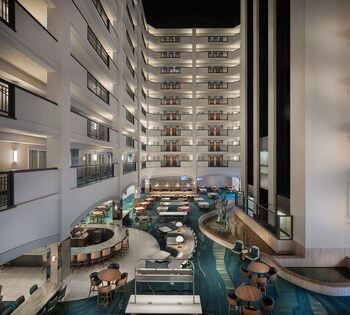 The reimagined atrium lobby creates a welcoming gathering space with flowing river-inspired patterns.