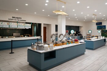 Guests enjoy Embassy Suites’ signature complimentary made-to-order breakfast in the hotel’s updated dining area.