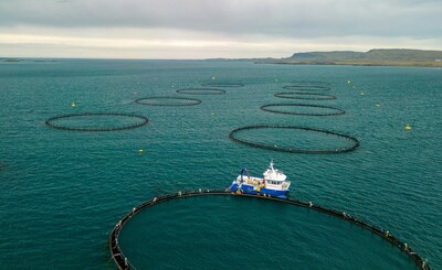 A fishing vessel works among offshore aquaculture pens in Berufjörður, Iceland. (Photo by Ed Wingate/Unsplash)