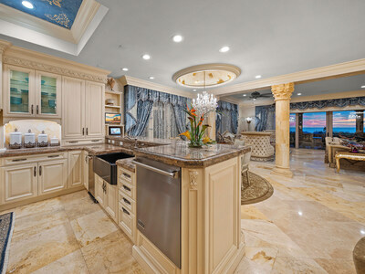 Fine finishes – with a touch of Mediterranean flair – define the home’s interiors. The gourmet kitchen offers bar seating, high-end appliances by Viking (2 dishwashers, a gas range, beverage cooler and ice machine) and Miele (steam oven, Nespresso machine), a custom refrigerator/freezer and a walk-in pantry. OceanfrontLuxuryAuction.com.