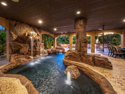 Outdoor living areas include this private, “grotto-style” pool on the ground level, which features rock waterfalls, a bubble fountain and laminar water jets. The pool was designed with the help of a Walt Disney World contractor. OceanfrontLuxuryAuction.com.