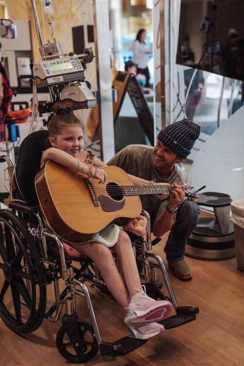 Noah Hicks delivering Love Your Melon hats to children |
Photo Credit: Colbi Carlson