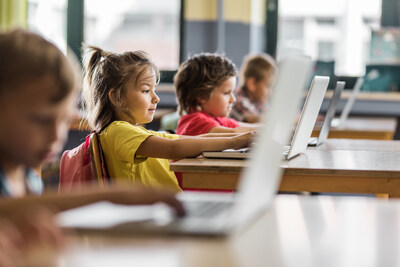 Elementary school kids using computer on a class in the classroom.
