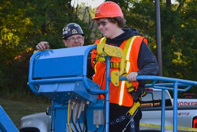 Student operates scissor lift at Brandon High School BYF