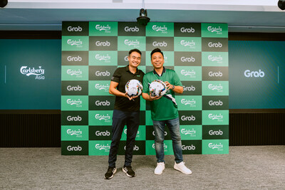 From left to right: Jerry Lim, Group Managing Director, Regional Head of Commercial and Support, and Jeff Chong, Director of International Premium Brands, Carlsberg Asia, mark a proud moment of unity as they sign a football symbolizing the spirit of teamwork, shared values, and the power of collaboration between Grab and Carlsberg.