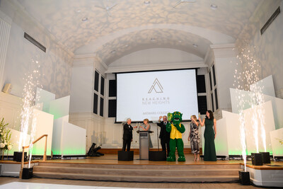 McDaniel Board of Trustees Chair Bruce Preston, McDaniel President Julia Jasken, campaign co-chair Ethan Seidel, Green Terror, campaign co-chair Debbie Seidel, and McDaniel student Nicki James raise a toast for the Reaching New Heights campaign