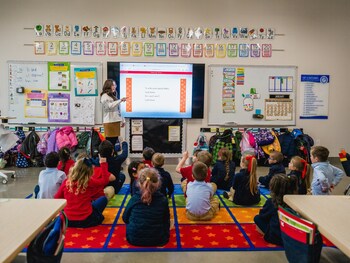 A Thales Academy teacher leads her students in a letter lesson.