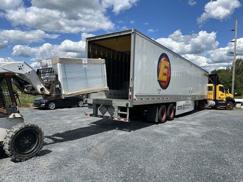 A forklift loads donated solar panels from Got Electric onto a transport truck bound for the Athens Area Habitat 
for Humanity ReStore in Georgia.