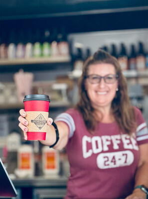A barista serves a specialty coffee drink at Horizons Coffee Bar, which opened recently in Bastrop, Texas.