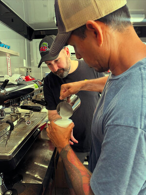 Project Manager and Trainer Steve Bayless of Crimson Cup Coffee and Tea (rear) supervises the creation of a specialty coffee drink at Horizons Coffee Bar in Bastrop, Texas.