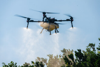 XAG P150 agricultural drone performs a precision spraying operation.