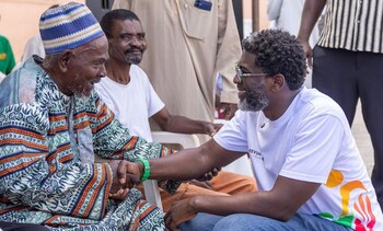Kevin Okyere interacting with community members during the Foundation World Food Day Outreach